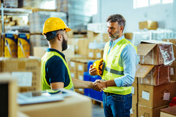 istock Businessman Having a Handshake With Warehouse Worker 1412177456