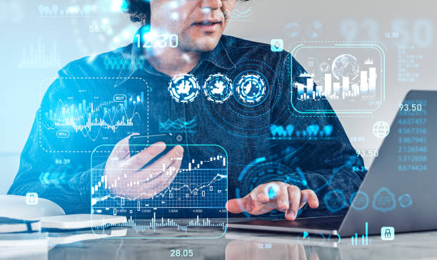 istock Businessman using phone, laptop and graph chart with financial data 1412177927