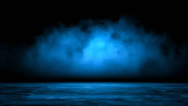 Abstract background with mystic blue smoke over old asphalt. Empty dark city street with horror atmosphere. Night scene with fog without people.