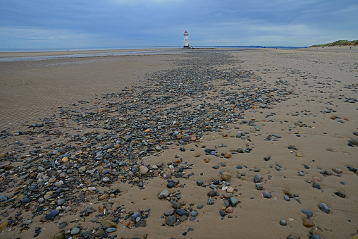 View of the sandy beach and its pebbles at low tide on  North Wales