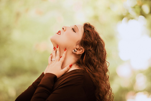 Young woman profile portrait with eyes closed and chin up