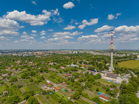 Drone point of view of TV tower in Dobrich, Bulgaria, agricultural fields, blue sky and cloudscape  (Bulgarian:Телевизионната кула, град Добрич, България). The scene is situated in Dobrich, Bulgaria and is taken with DJI qudracopter Mavic IIIDrone point of view of TV tower in Dobrich, Bulgaria, agricultural fields, blue sky and cloudscape  (Bulgarian:Телевизионната кула, град Добрич, България).The scene is situated in Dobrich, Bulgaria and is taken with DJI qudracopter Mavic III