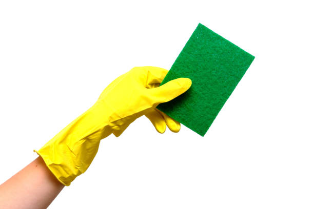 istock Hand with yellow gloves and sponge 1412184642
