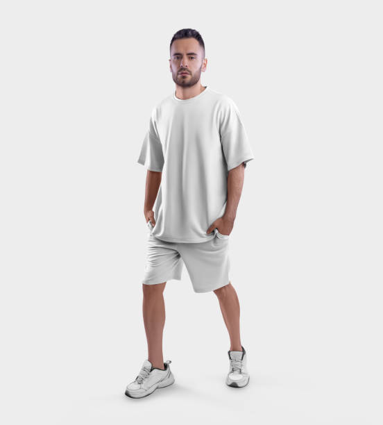 Oversized white t-shirt template, shorts on a walking bearded guy in sneakers, with hands in pockets front view, isolated on background.
