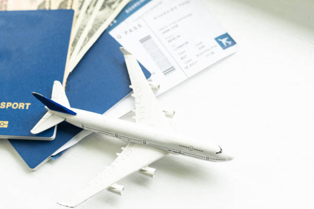 istock Passport, boarding pass and toy airplane on table top view 1412189927