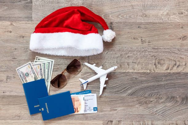 istock passport, toy plane and red santa hat 1412189967