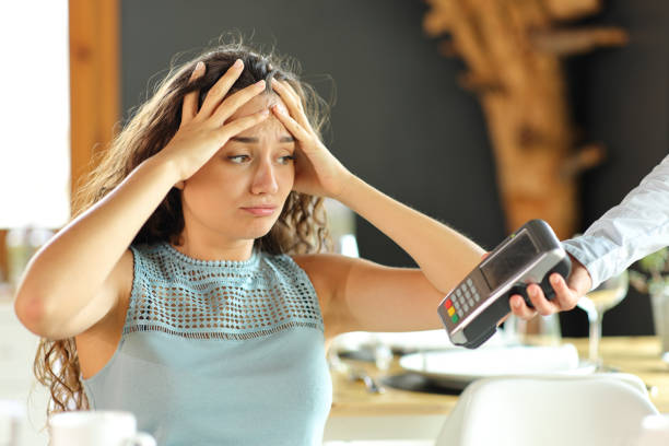 Woman complaining about expensive restaurant bill stock photo