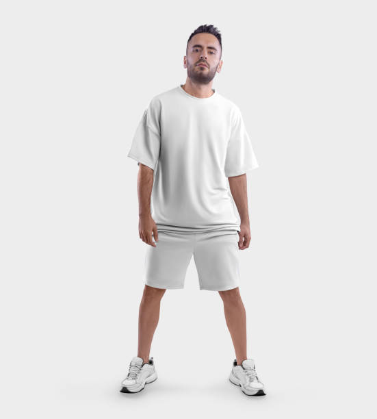 istock Oversized white t-shirt template, shorts on posing bearded guy in sneakers, front view, isolated on background. 1412189995