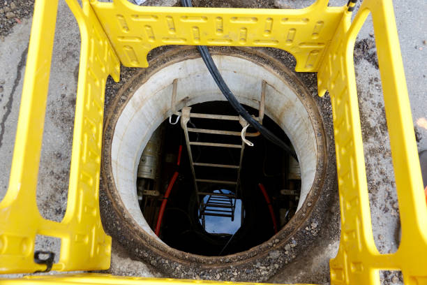 Safety barrier around an open manhole in the street Safety barrier around an open manhole in the street manhole stock pictures, royalty-free photos & images