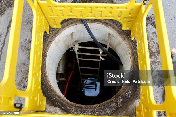 Safety Barrier Around An Open Manhole In The Street Stock Photo - Download Image Now