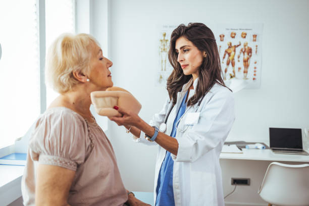 istock Doctor putting a neck brace on a senior patient 1412190334