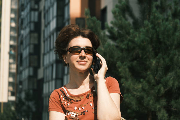 istock Woman is talking by phone 1412191979