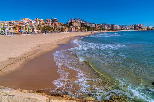 Villajoyosa Spain beautiful sandy beach and clear blue sea with colourful houses and palm trees Costa Blanca Alicante