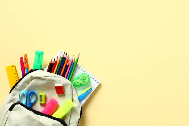 istock Back to school concept. Backpack with colorful school supplies inside. Flat lay, top view, copy space. 1412195433