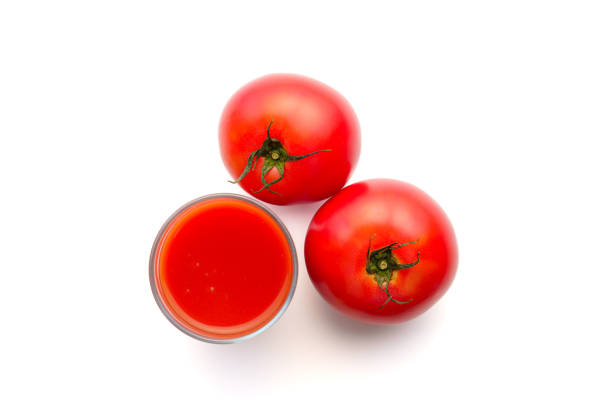 Tomato juice in glass on white background