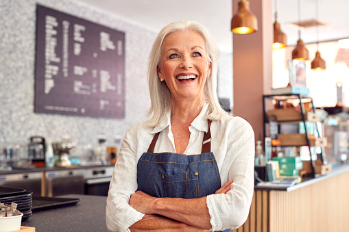 Portrait Of Female Owner Working In Coffee Shop Or Restaurant