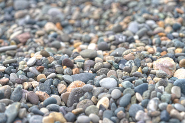 Wet pebble on a sea beach in overcast morning, top view