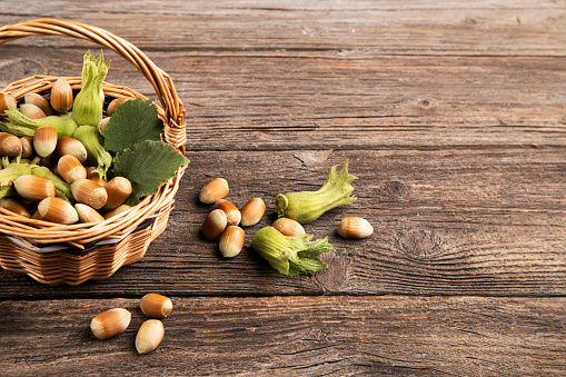 Raw hazelnuts on wooden table