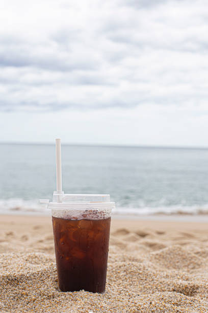 Cold coffee on beach with sea in background