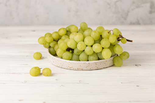 fresh juicy white and red grapes on plate