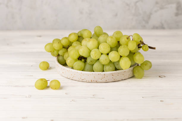 fresh juicy grapes on plate fresh juicy white and red grapes on plate Green Grapes stock pictures, royalty-free photos & images