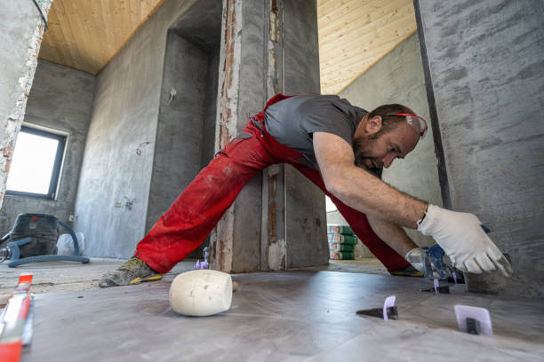 istock Professional builder measuring and leveling the tiled floor 1412203499