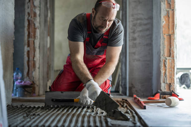 istock Man applying tile adhesive on the floor 1412203500