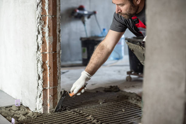 istock Man applying tile adhesive on the floor 1412203511