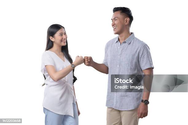 Southeast Asian Couple Fistbump Stock Photo - Download Image Now - Fist Bump, Young Women, 25-29 Years