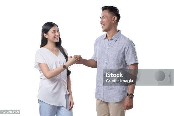 Southeast Asian Couple Fistbump Stock Photo - Download Image Now - Couple - Relationship, Fist Bump, 25-29 Years