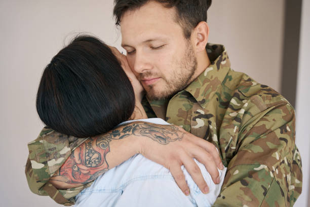 istock Soldier going to war hugging his wife 1412206595