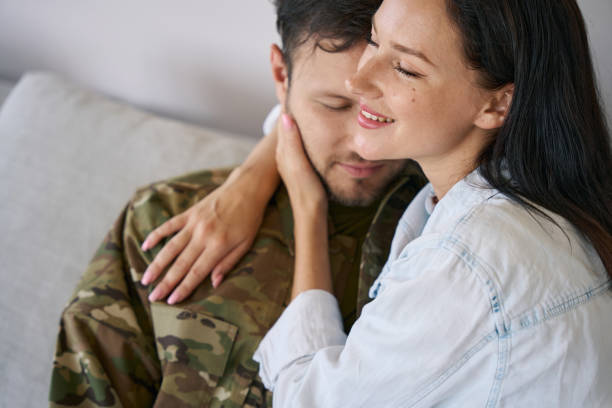 istock Happy wife embracing husband back from war 1412206608