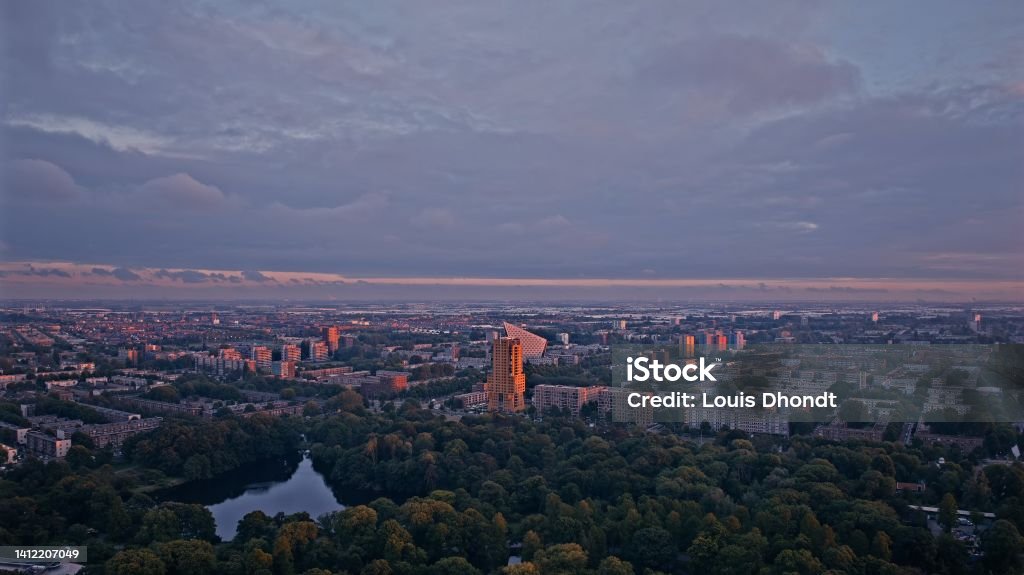 Sunset in The Hague, with view of the Escamp Municipal District Officecity hall (Stadsdeelkantoor Escamp) Zuiderpark, The Hague, Netherlands:

Drone photograph of The Hague (Den Haag), showing the skyline at sunset Aerial View Stock Photo