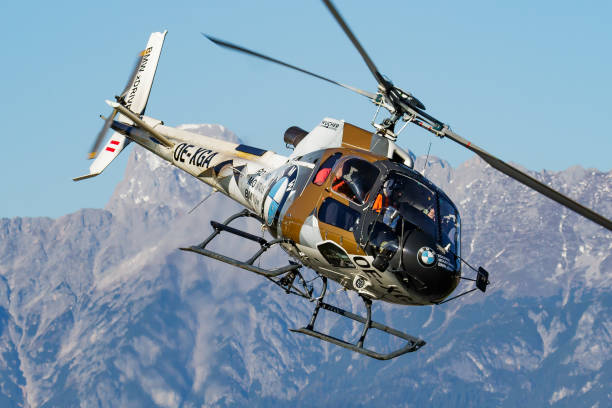 Commercial helicopter at airport and airfield. Rotorcraft. General aviation industry. Civil utility transportation. Air transport. Fly and flying. Zell am See, Austria - October 14, 2017: Commercial helicopter at airport and airfield. Rotorcraft. General aviation industry. Civil utility transportation. Air transport. Fly and flying. tilt rotor stock pictures, royalty-free photos & images