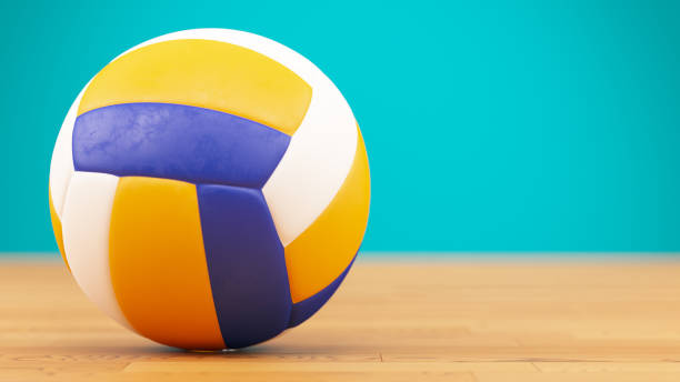 volleyballball auf parkettplatz - volleyball sport floor ball stock-fotos und bilder