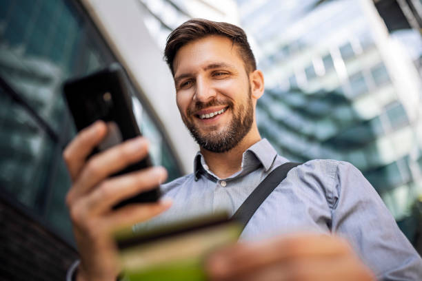 istock Smiling businessman shopping online 1412209084