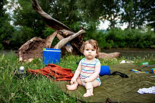 Baby girl enjoying day in nature on picnic