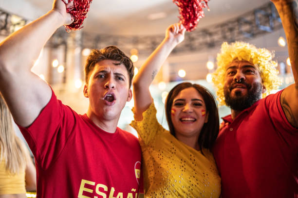 istock Spanish friends watching a soccer game and celebrating at a bar 1412210107