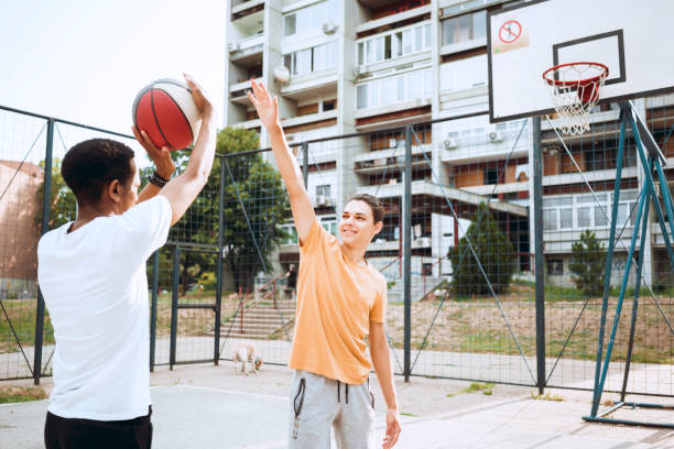 istock Friends playing basketball 1412210316
