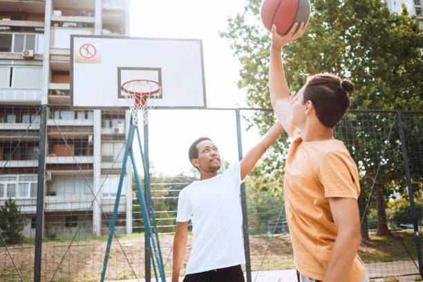 istock Friends playing basketball 1412210332