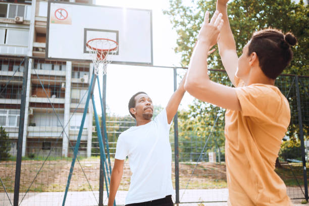 istock Friends playing basketball 1412210505