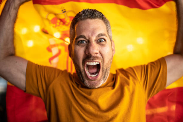 istock Mid adult man celebrating with a spanish flag 1412210610