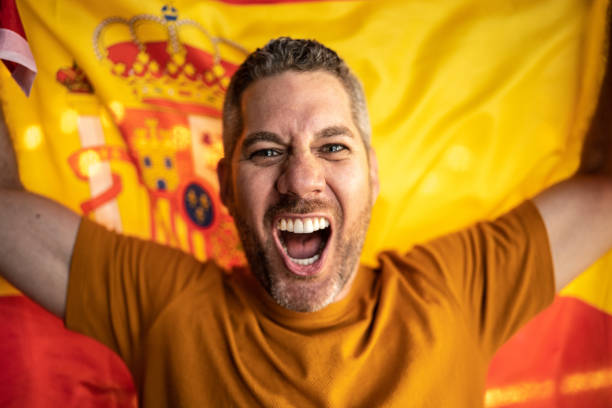 istock Mid adult man celebrating with a spanish flag 1412210684