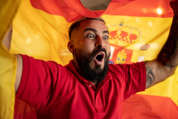 istock Mid adult hispanic man celebrating with spanish flag 1412211076