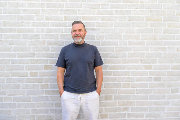 istock Trendy casual man posing in front of a brick wall 1412211974