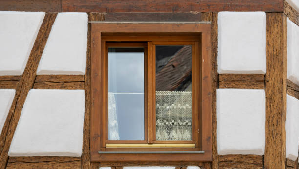istock Windows and lace curtain on an old house 1412212105