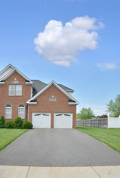istock Suburaban Home Two Car Garage Blacktop Driveway 141221259