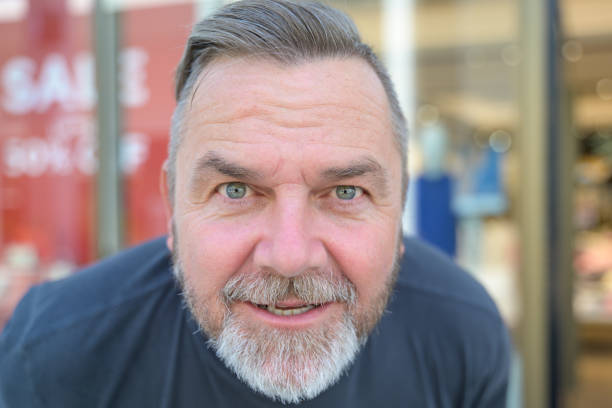 istock Senior man leaning forwards staring into the camera 1412213875