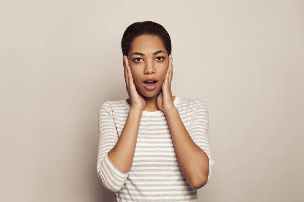 istock Happy surprised woman on white background 1412214259
