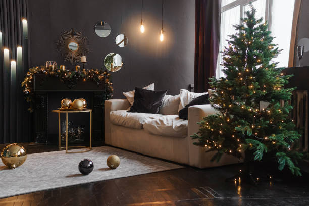 istock Christmas interior with a beautiful Christmas tree, sofa, light bulbs and dark background. 1412214891